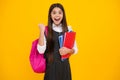 Amazed teen girl. Back to school. School girl student with school bag backpack hold book on isolated studio background Royalty Free Stock Photo