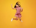 Amazed teen girl. Excited expression, cheerful and glad. Full length of excited teenager child in summer dress jump Royalty Free Stock Photo