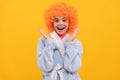 amazed teen girl in fancy orange wig hair wear home bathrobe, amazement