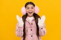 amazed teen girl in mittens. portrait of child wearing warm clothes.