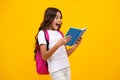 Amazed teen girl. School teenager child girl with school backpack hold book and copybook. Teenager student, isolated Royalty Free Stock Photo