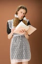 Amazed teen girl in school uniform reading book