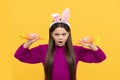 amazed teen kid in easter bunny ears with carrot, bunny hunt