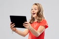 Amazed teenage girl with tablet computer