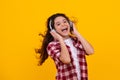 Amazed teenager. Young teen child listening music with headphones. Girl listening songs via wireless headphones Royalty Free Stock Photo