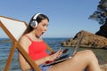 Amazed tourist looking at her laptop on the beach Royalty Free Stock Photo