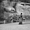 An amazed tourist looks with awe at the huge Buddha