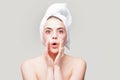 Amazed woman applying eye patches. Close up portrait girl with towel on head. Portrait of beauty woman with eye patches Royalty Free Stock Photo