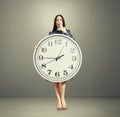 Amazed woman with big white clock Royalty Free Stock Photo