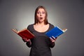 Amazed woman with books