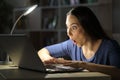 Amazed woman checking laptop at night at home Royalty Free Stock Photo