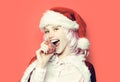 Amazed woman in christmas santa hat holds christmas ball. Closeup funny face portrait Royalty Free Stock Photo