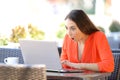 Amazed woman finding surprising content on a laptop Royalty Free Stock Photo