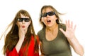 Amazed woman and girl in cinema wearing 3D glasses experiencing 5D cinema effect - scared watching performance - gestures of