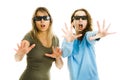 Amazed woman and girl in cinema wearing 3D glasses experiencing 5D cinema effect - scared watching performance - gestures of