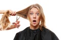 Amazed woman with long hair and scissors