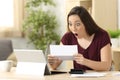 Amazed woman reading good news in a letter