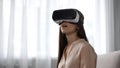 Amazed woman using VR headset for first time, overwhelmed with positive emotions