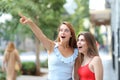 Amazed women pointing at landmark in the street