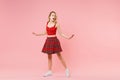 Amazed young blonde woman girl in red sexy clothes isolated on pastel pink background studio portrait. People sincere Royalty Free Stock Photo