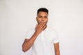 Amazed young man covering his mouth with hand Royalty Free Stock Photo