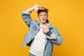 Amazed young man in denim casual clothes looking camera making hands photo frame gesture isolated on yellow orange Royalty Free Stock Photo