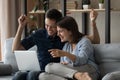 Amazed young man woman couple looking at laptop screen. Royalty Free Stock Photo