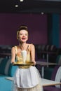 amazed young pin up waitress holding Royalty Free Stock Photo