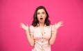 Amazed young woman over pink background Royalty Free Stock Photo