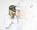 Amazed young women wearing virtual reality goggles dispersing into pixels effect Royalty Free Stock Photo