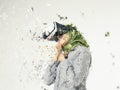 Amazed young women wearing virtual reality goggles dispersing into pixels effect Royalty Free Stock Photo