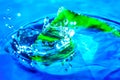 Amazing abstract shot of water drop splash near the green leaf in water. Nature background. Macro shot with selective focus Royalty Free Stock Photo