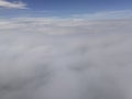 Amazing aerial landscape, skyline above the clouds, view from airplane.Clouds background with blur effect and copy space Royalty Free Stock Photo