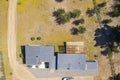 Amazing aerial overhead view of the Chilean countryside. A rural house with its farmland and the forest trees. Idyllic scenery