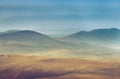 Amazing aerial view of desert, stone hills, and distant mountains layers range.Wilderness background. Near Mount Erciyes. Kayseri, Royalty Free Stock Photo