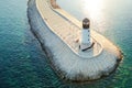 Amazing aerial view of lighthouse and dam on Lustica bay near Tivat, Montenegro on sunny day