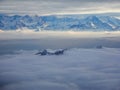 Amazing aerial view of misty swiss alps and clouds above the mountain peaks from airplane Royalty Free Stock Photo