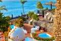 Amazing Aerial view on palm trees and ocean at summer sunset. Man sunbathes by the pool Royalty Free Stock Photo