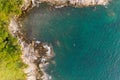 Amazing Aerial view of Seashore cliffs sunset in Phuket island. Aerial seascape with Kayak boat in clear turquoise water,waves in