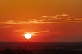 An amazing African sunset over the rolling hills in Bemelen, south Limburg, with the sun as a yellow ball of fire and an orange sk Royalty Free Stock Photo