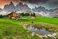 Spectacular alpine chalets with mountain lake in Dolomites, Italy, Europe Royalty Free Stock Photo