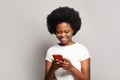 Amazing application. Happy black woman using smartphone on white background Royalty Free Stock Photo