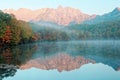 Amazing autumn lake scenery of Kagami Ike Mirror Pond in morning light with symmetric reflections of colorful fall foliage Royalty Free Stock Photo