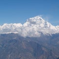 Amazing autumn panorama with mountains covered with snow and forest against the background of blue sky and clouds. Mount Everest, Royalty Free Stock Photo