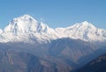 Amazing autumn panorama with mountains covered with snow and forest against the background of blue sky and clouds. Mount Everest, Royalty Free Stock Photo