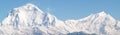 Amazing autumn panorama with mountains covered with snow and forest against the background of blue sky and clouds. Mount Everest, Royalty Free Stock Photo