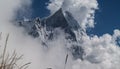 Amazing autumn panorama with mountains covered with snow and forest against the background of blue sky and clouds. Mount Everest,