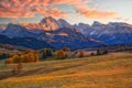 Amazing autumn scenery of Alpe di Siusi at sunrise. Majestic mountains and colorful sky in background, Dolomites, Italy Royalty Free Stock Photo