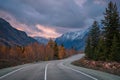 Road asphalt mountains sunset clouds sky autumn Royalty Free Stock Photo