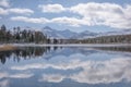 Mountains lake forest snow clouds reflection autumn Royalty Free Stock Photo